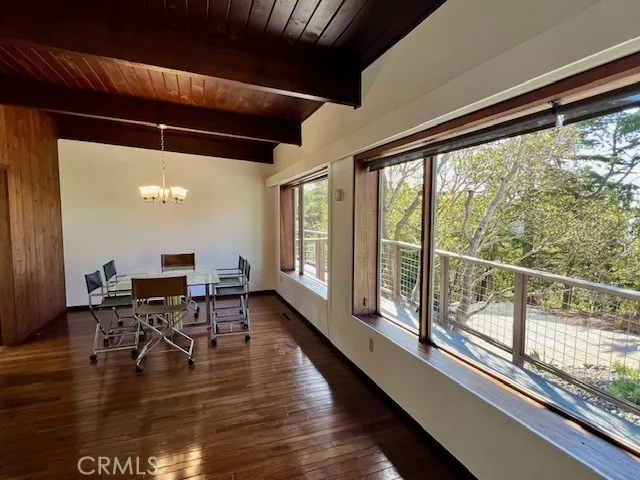 a dining room with furniture window and wooden floor