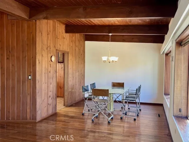 a dining room with furniture and wooden floor