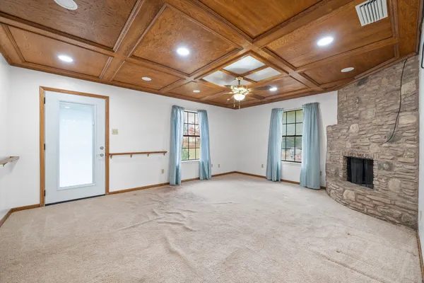 a view of an empty room with a fireplace