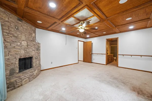 a view of an empty room with brick wall and a fireplace