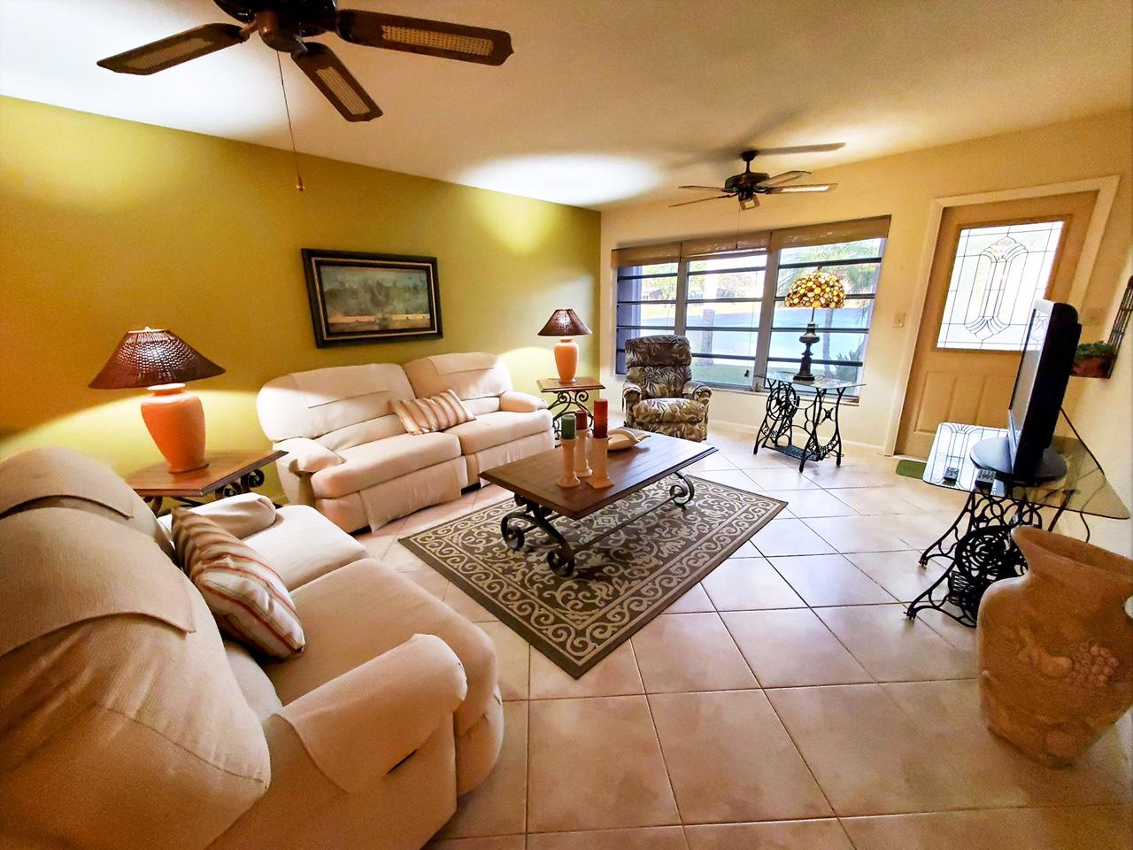 18760 Garbo Terrace, Unit 7 Boca Raton, FL 33496 - Photo 5 of 13 a living room with furniture and a flat screen tv