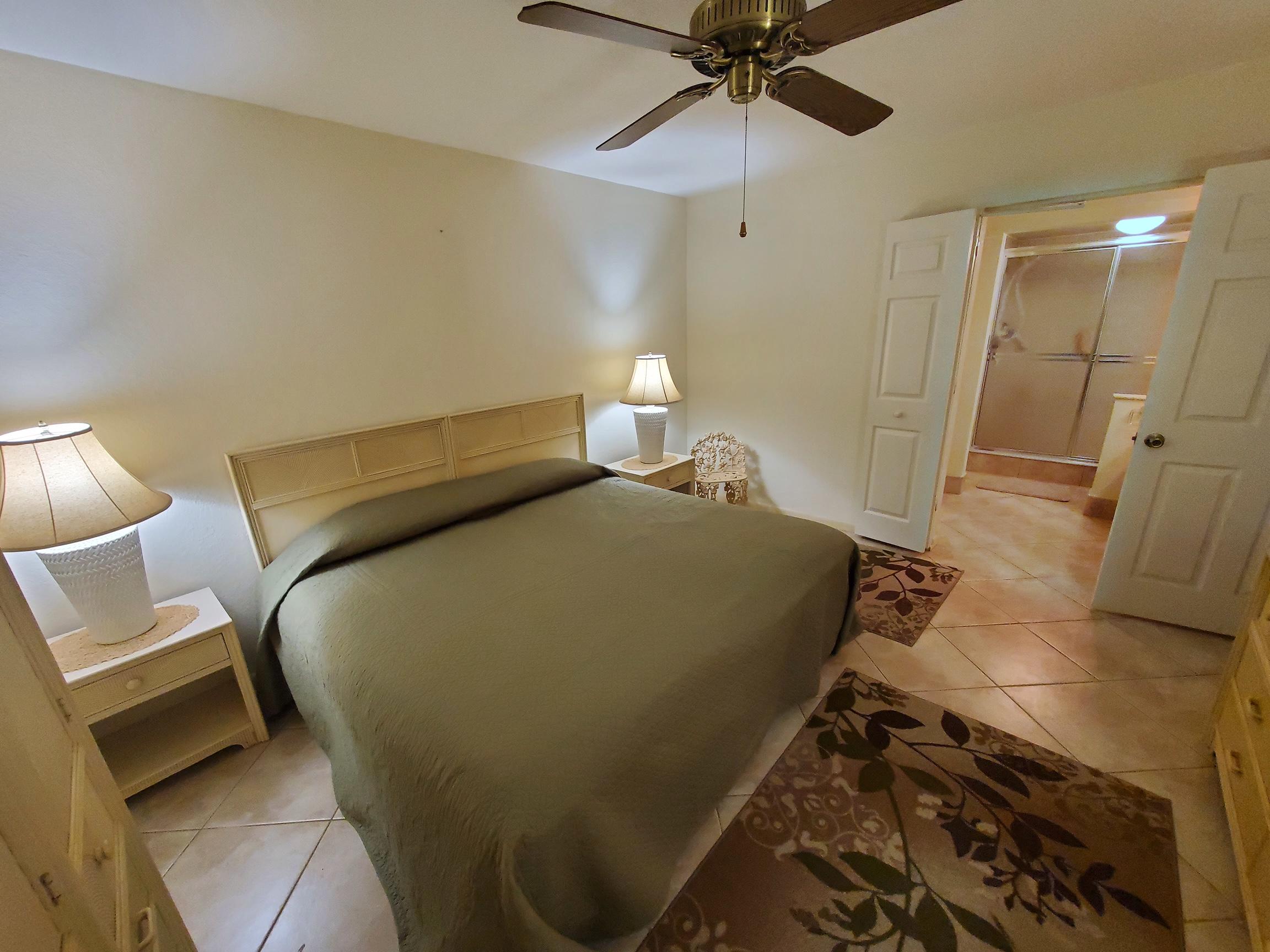 18760 Garbo Terrace, Unit 7 Boca Raton, FL 33496 - Photo 8 of 13 a bedroom with a bed and a lamp