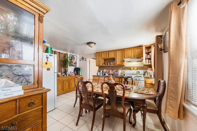 a view of a dining room with furniture and a window