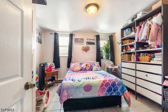 a bedroom with a bed and a book shelf
