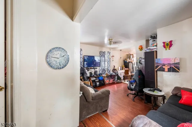 a living room with lots of furniture and a painting