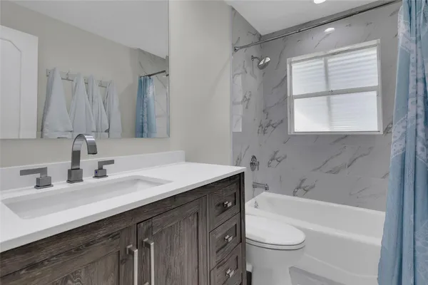 a view of a house with backyard porch and sitting area