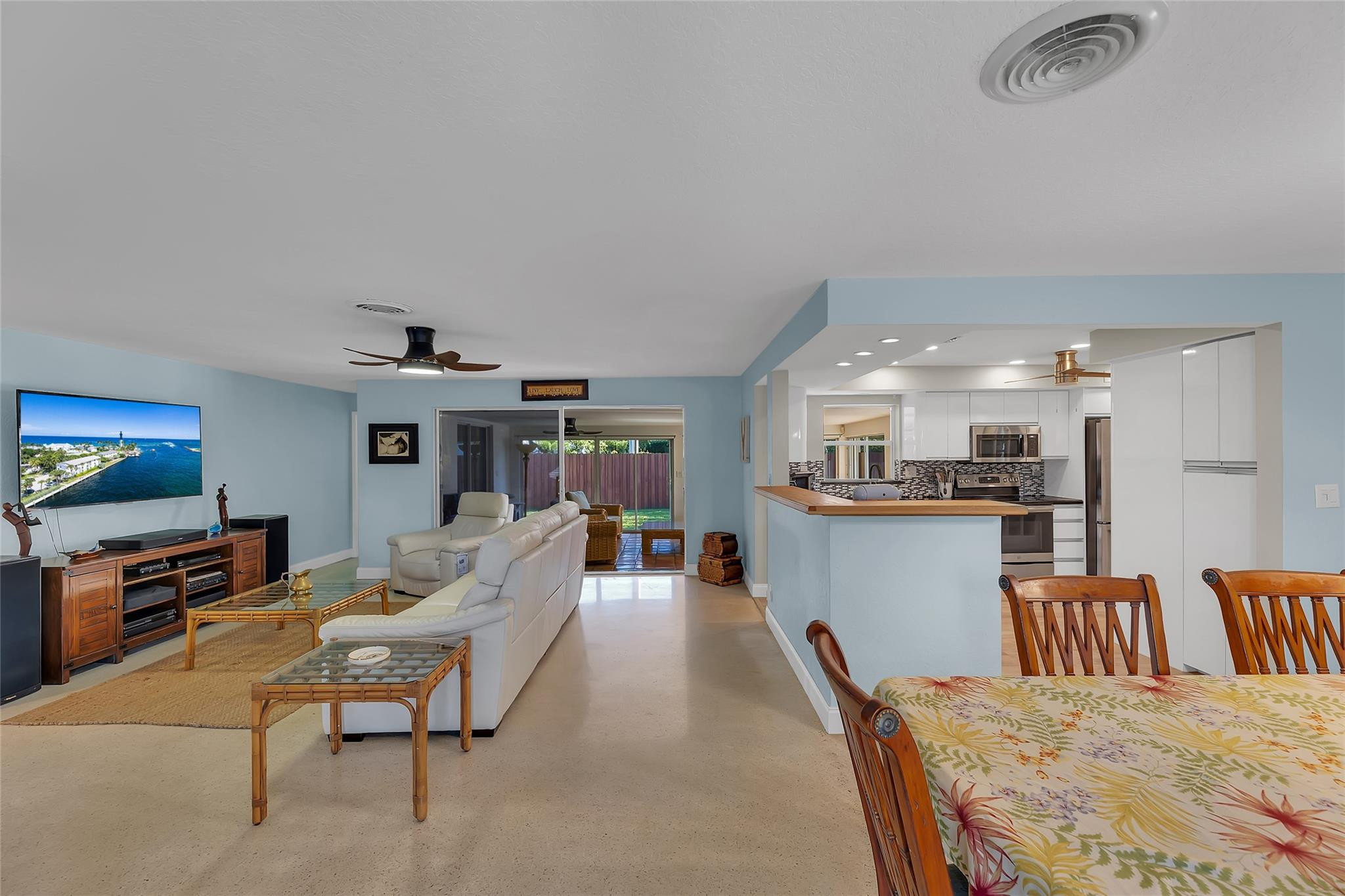 3404 Barton Road Pompano Beach, FL 33062 - Photo 5 of 46 a living room with furniture a flat screen tv and a refrigerator