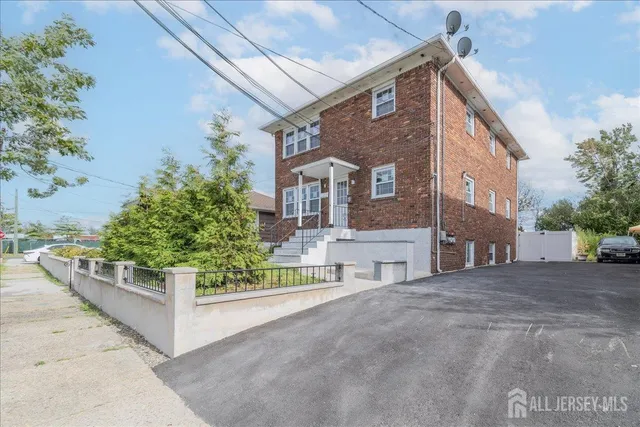 a view of a house with patio and a yard