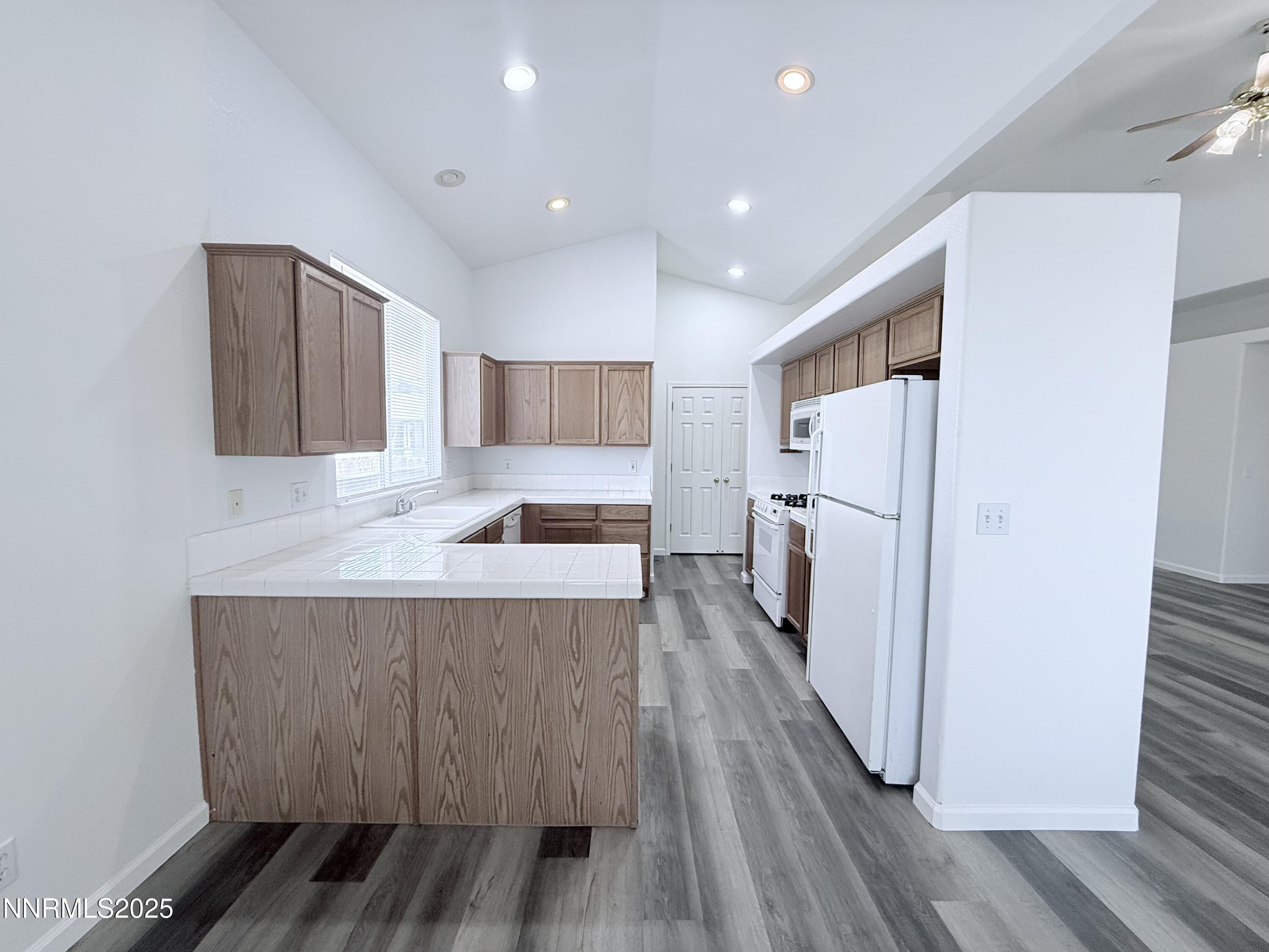 7539 Michaela Drive Reno, NV 89511 - Photo 12 of 33 a view of a kitchen with wooden floor and electronic appliances