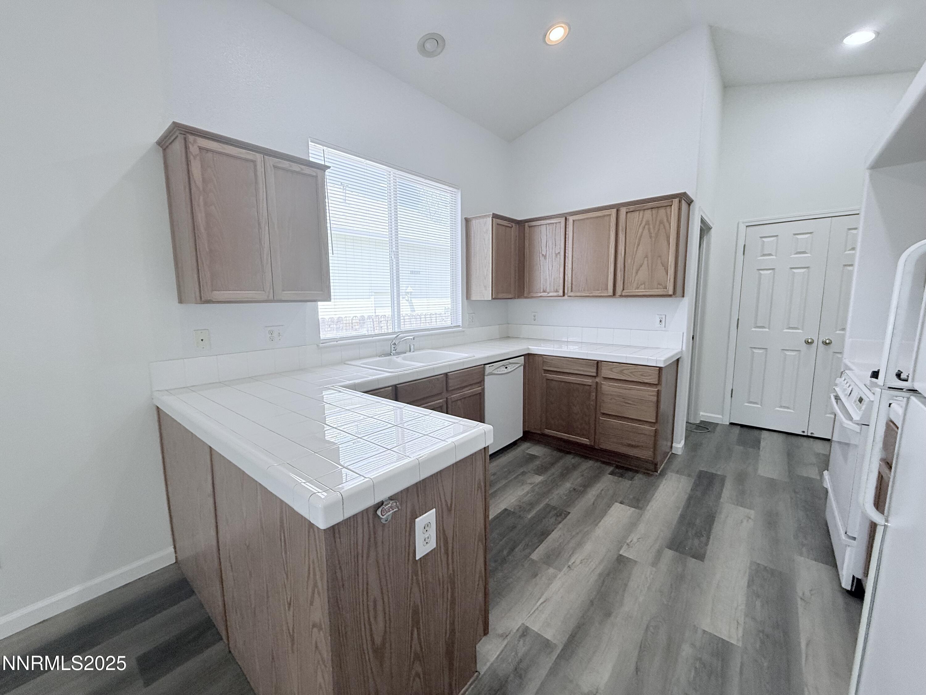 7539 Michaela Drive Reno, NV 89511 - Photo 15 of 33 a kitchen with a sink stove and cabinets