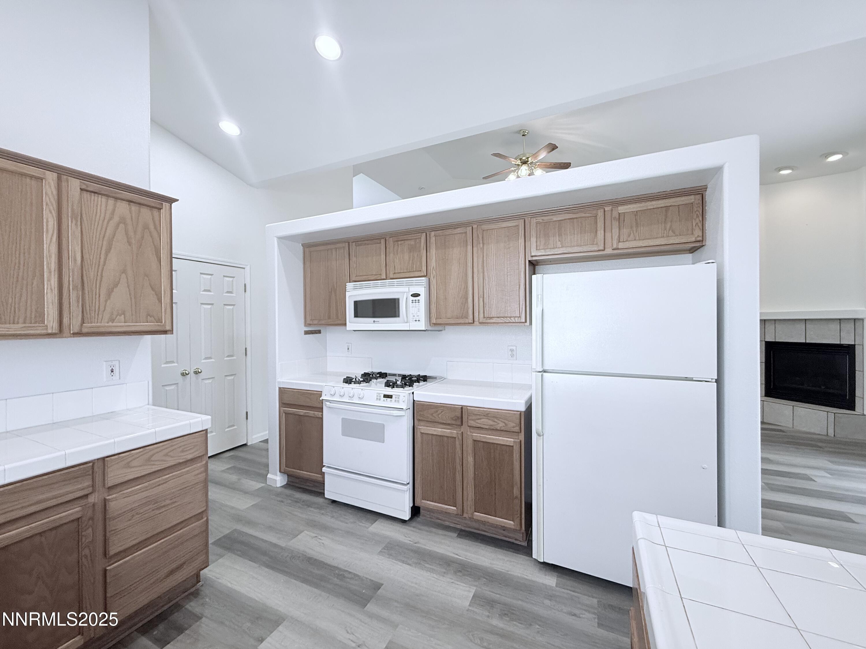 7539 Michaela Drive Reno, NV 89511 - Photo 17 of 33 a kitchen with a sink stainless steel appliances and white cabinets