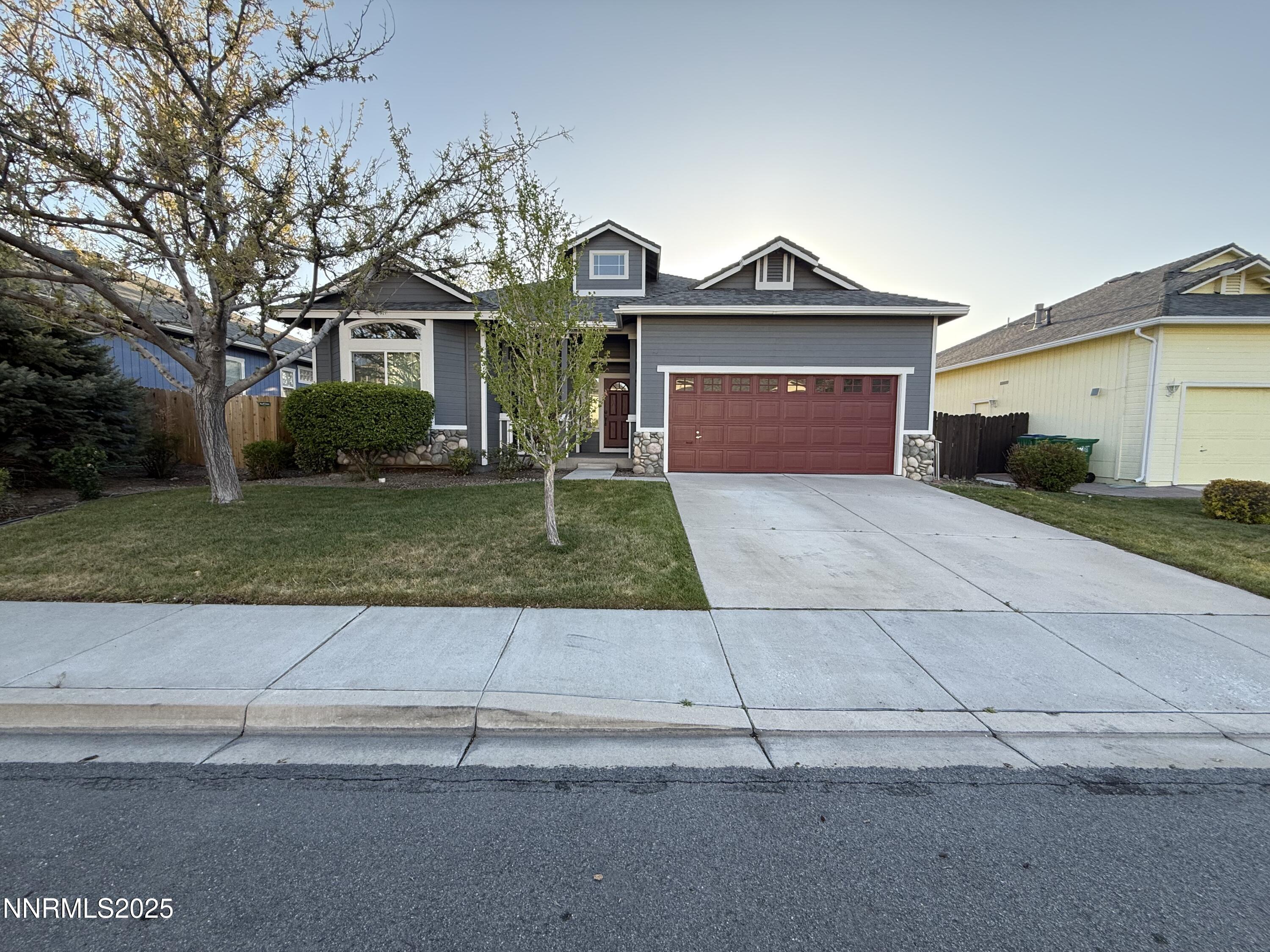 7539 Michaela Drive Reno, NV 89511 - Photo 2 of 33 a front view of a house with a yard and garage