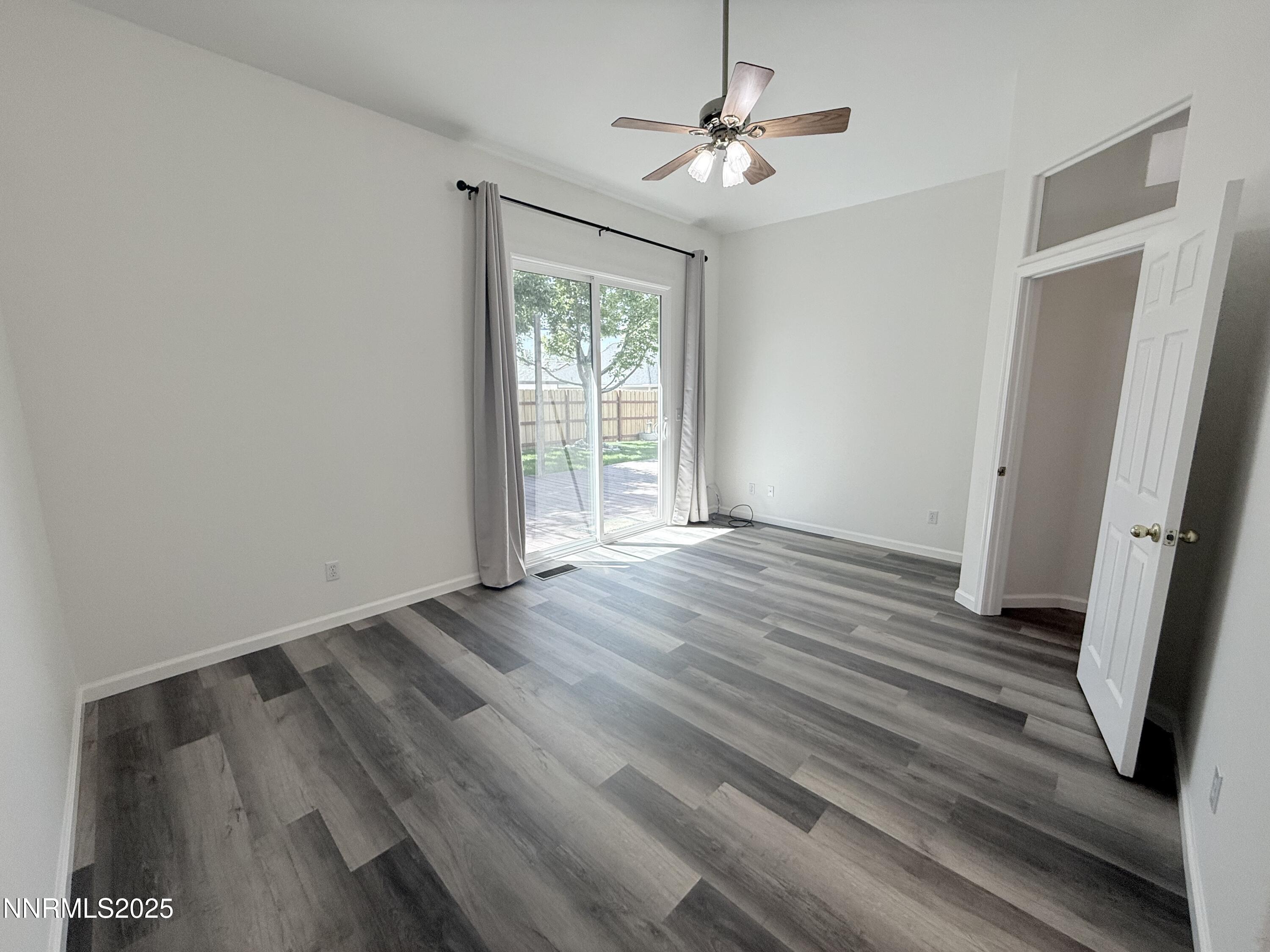 7539 Michaela Drive Reno, NV 89511 - Photo 22 of 33 wooden floor in an empty room with a window