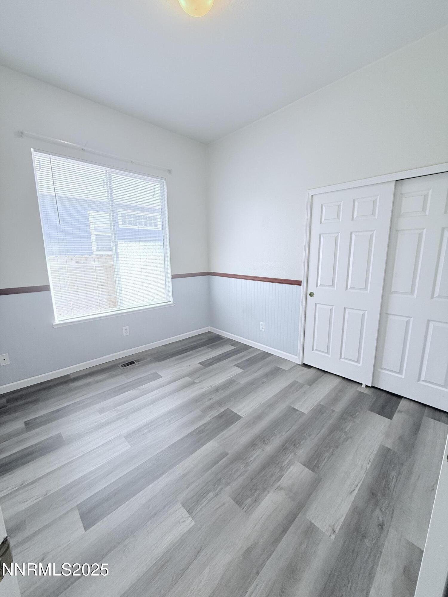 7539 Michaela Drive Reno, NV 89511 - Photo 29 of 33 a view of an empty room with wooden floor and a window