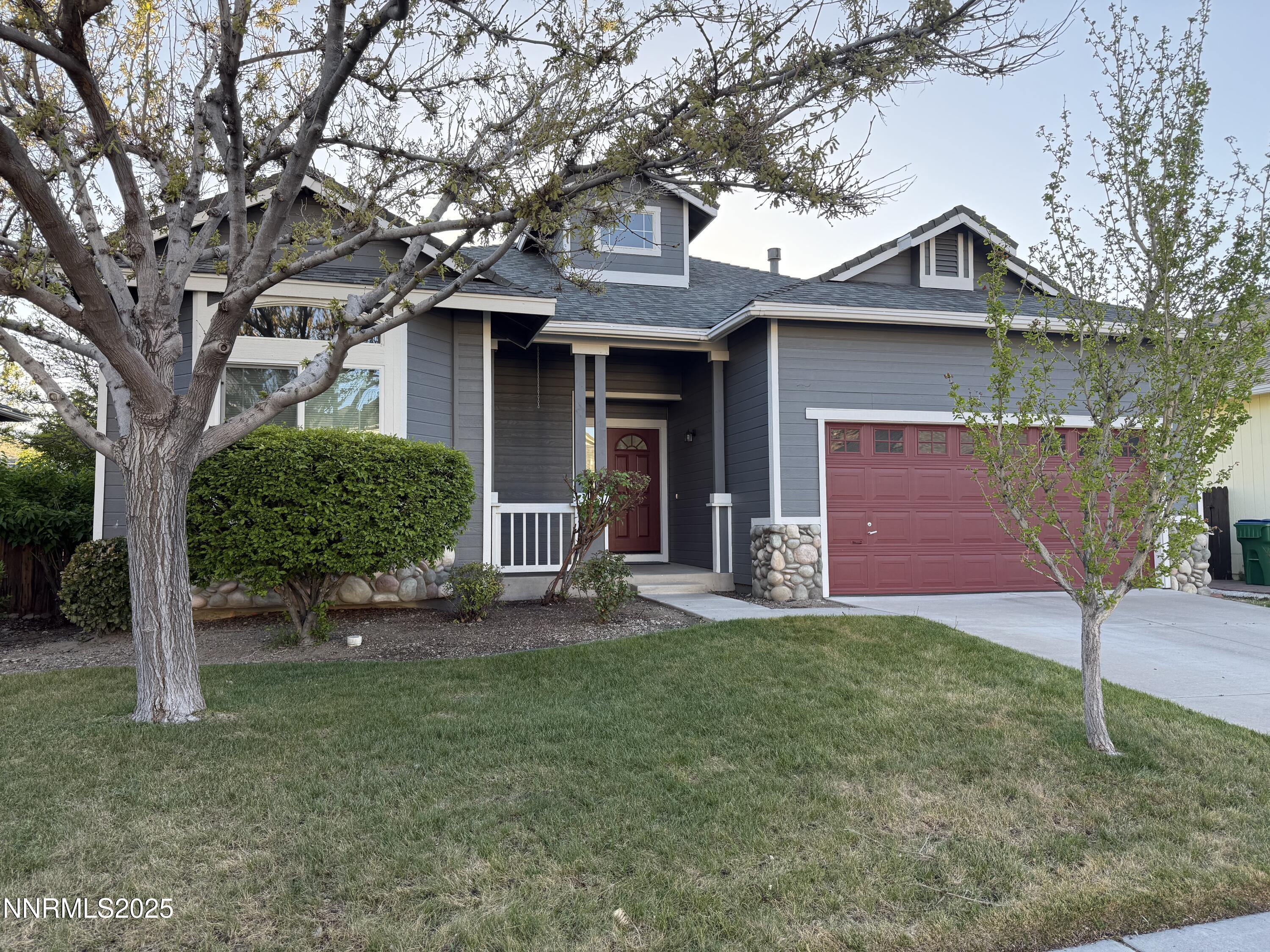 7539 Michaela Drive Reno, NV 89511 - Photo 3 of 33 a front view of a house with a yard and garage