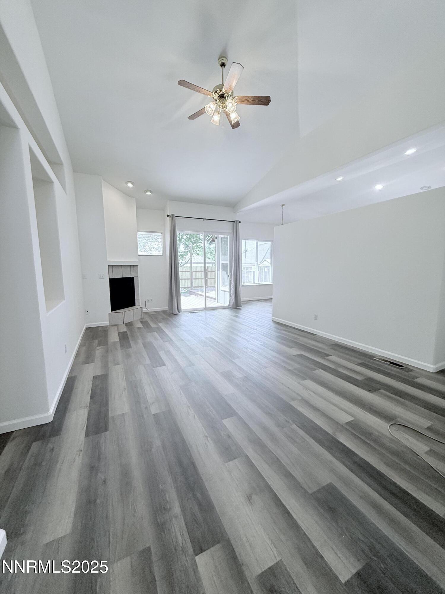 7539 Michaela Drive Reno, NV 89511 - Photo 7 of 33 wooden floor in an empty room with a window