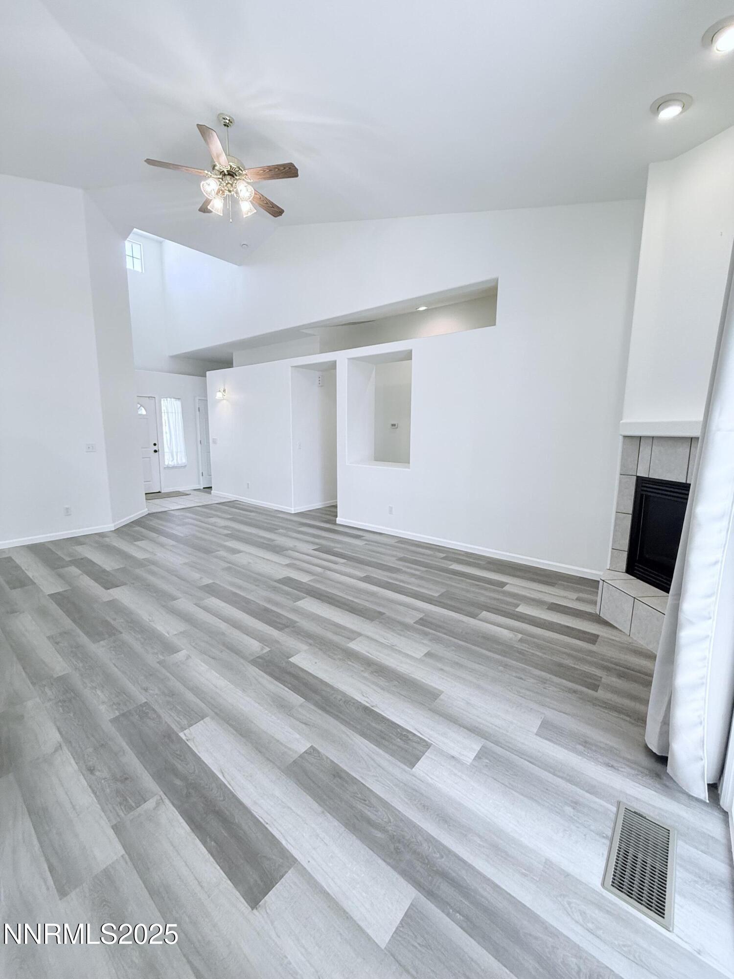 7539 Michaela Drive Reno, NV 89511 - Photo 9 of 33 a view of an empty room with a chandelier fan