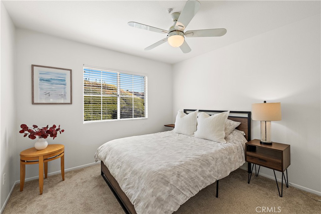 23 Cassis Dana Point, CA 92629 - Photo 12 of 19 a bedroom with a bed and a chair