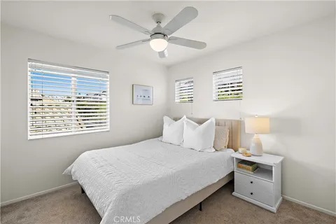 a bedroom with a large bed and a window