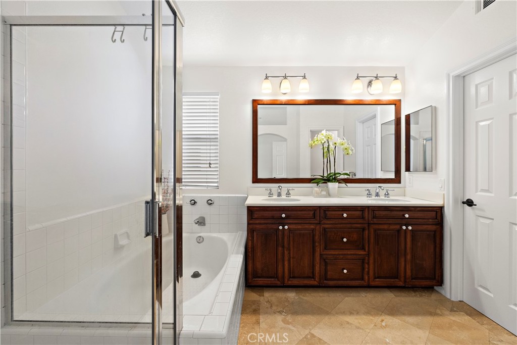 23 Cassis Dana Point, CA 92629 - Photo 16 of 19 a bathroom with a double vanity sink and mirror
