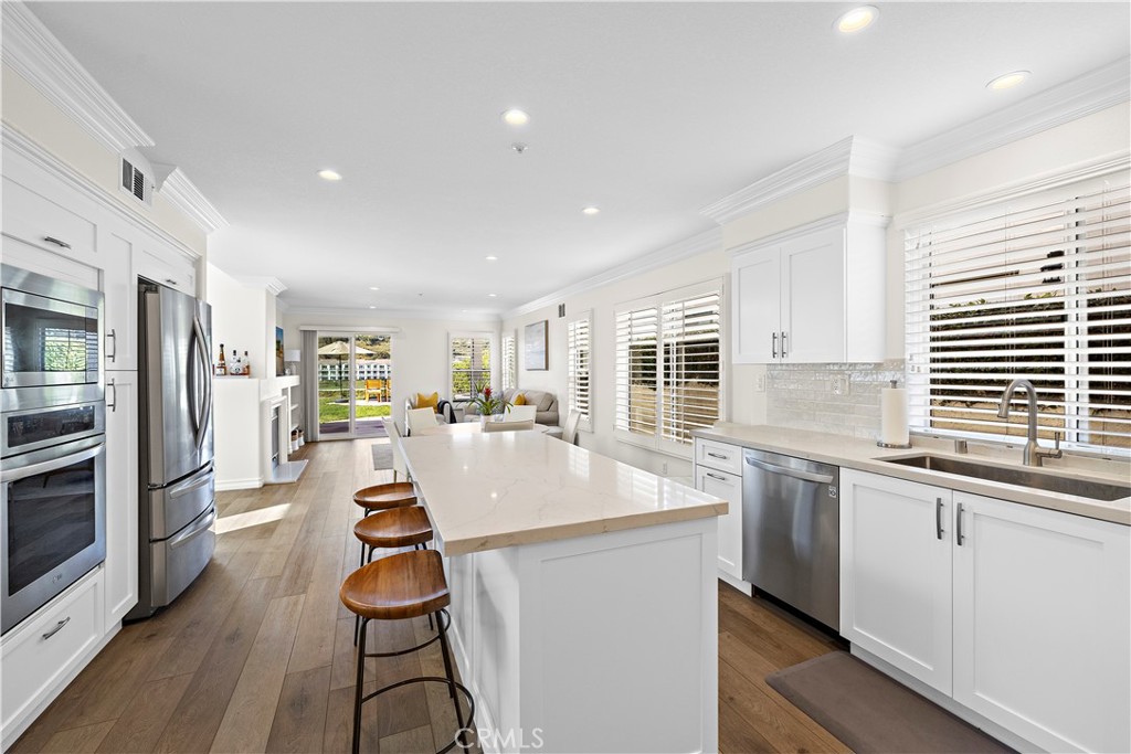 23 Cassis Dana Point, CA 92629 - Photo 8 of 19 a kitchen with stainless steel appliances granite countertop a sink and a refrigerator