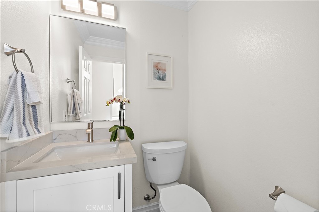 23 Cassis Dana Point, CA 92629 - Photo 9 of 19 a bathroom with a toilet sink and mirror
