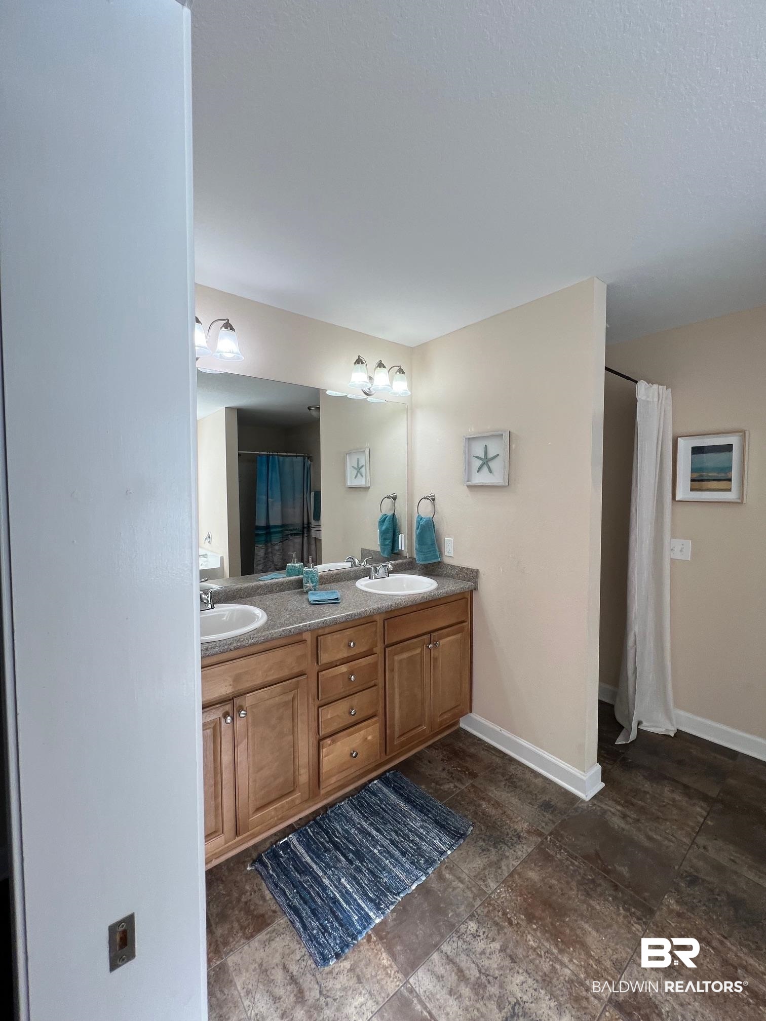 10257 Lyttleton Loop Lillian, AL 36549 - Photo 16 of 31 Bathroom with double vanity and a stall shower