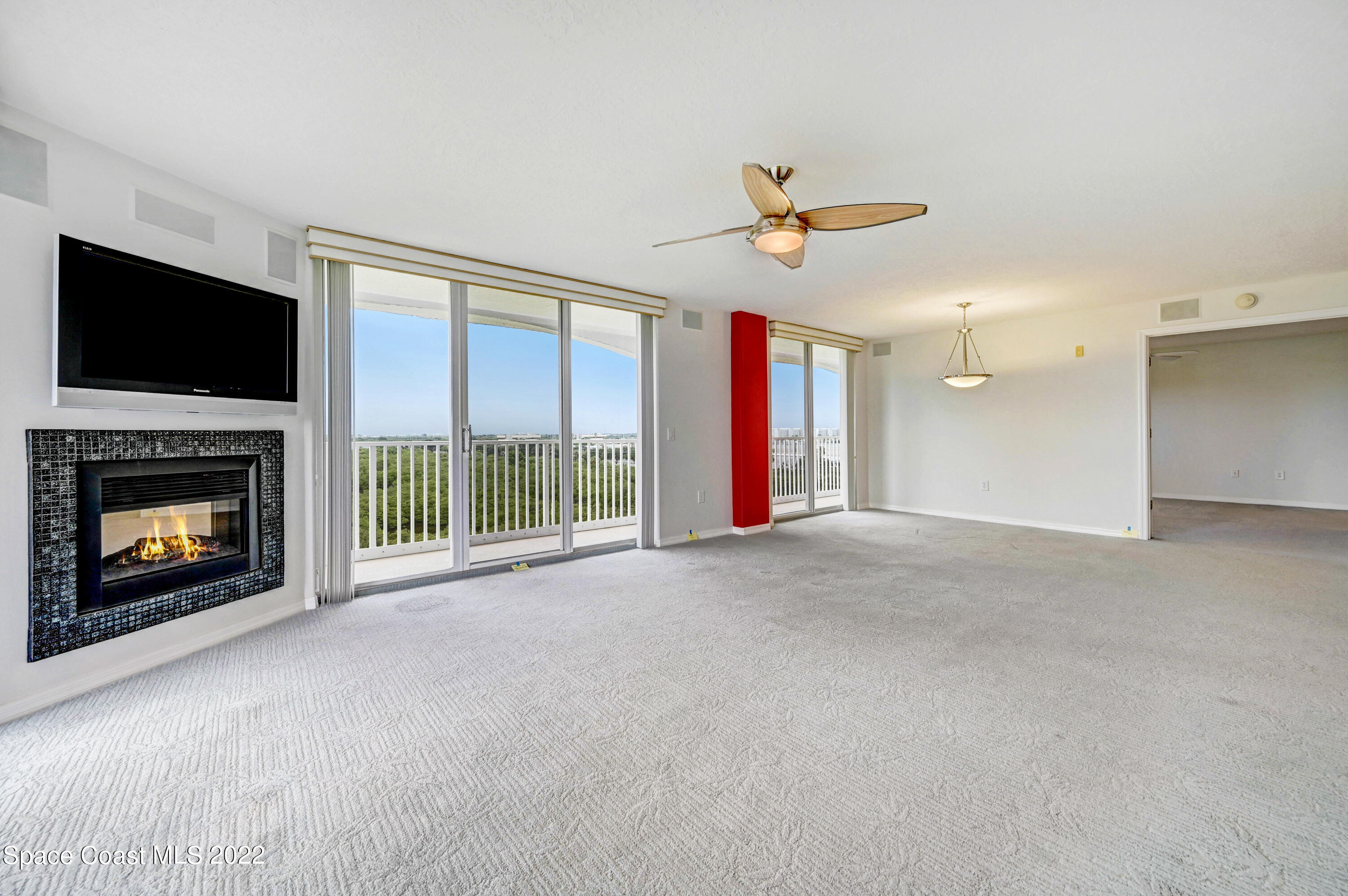 801 Del Rio Way, Unit 602 Merritt Island, FL 32953 - Photo 13 of 36 a view of an empty room with a fireplace and a window