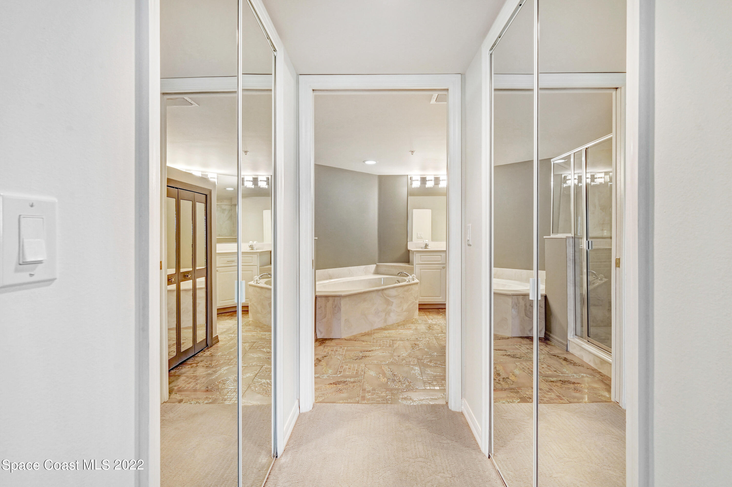 801 Del Rio Way, Unit 602 Merritt Island, FL 32953 - Photo 16 of 36 a bathroom with a glass shower door and mirror