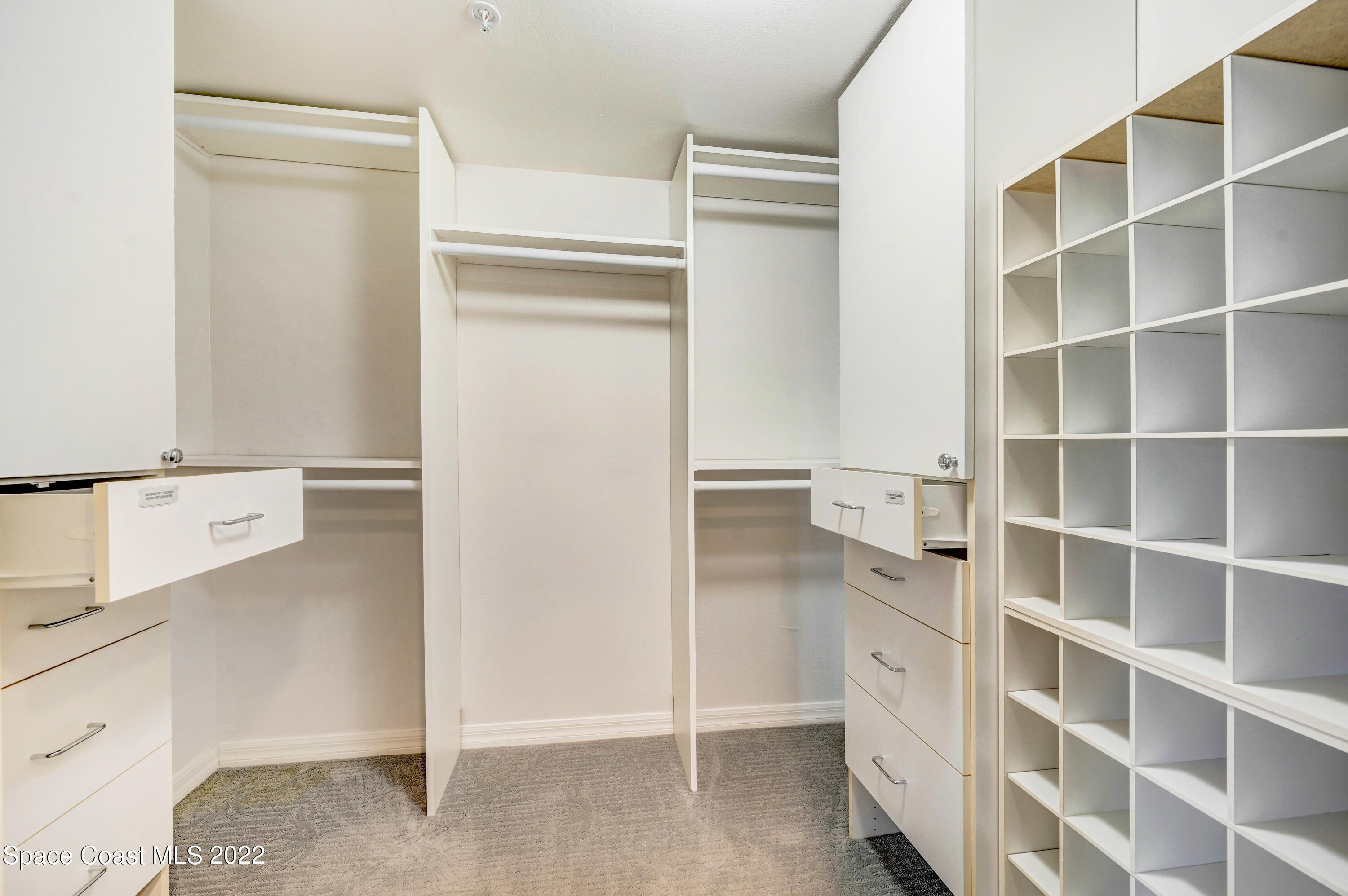 801 Del Rio Way, Unit 602 Merritt Island, FL 32953 - Photo 17 of 36 a view of walk in closet with empty racks