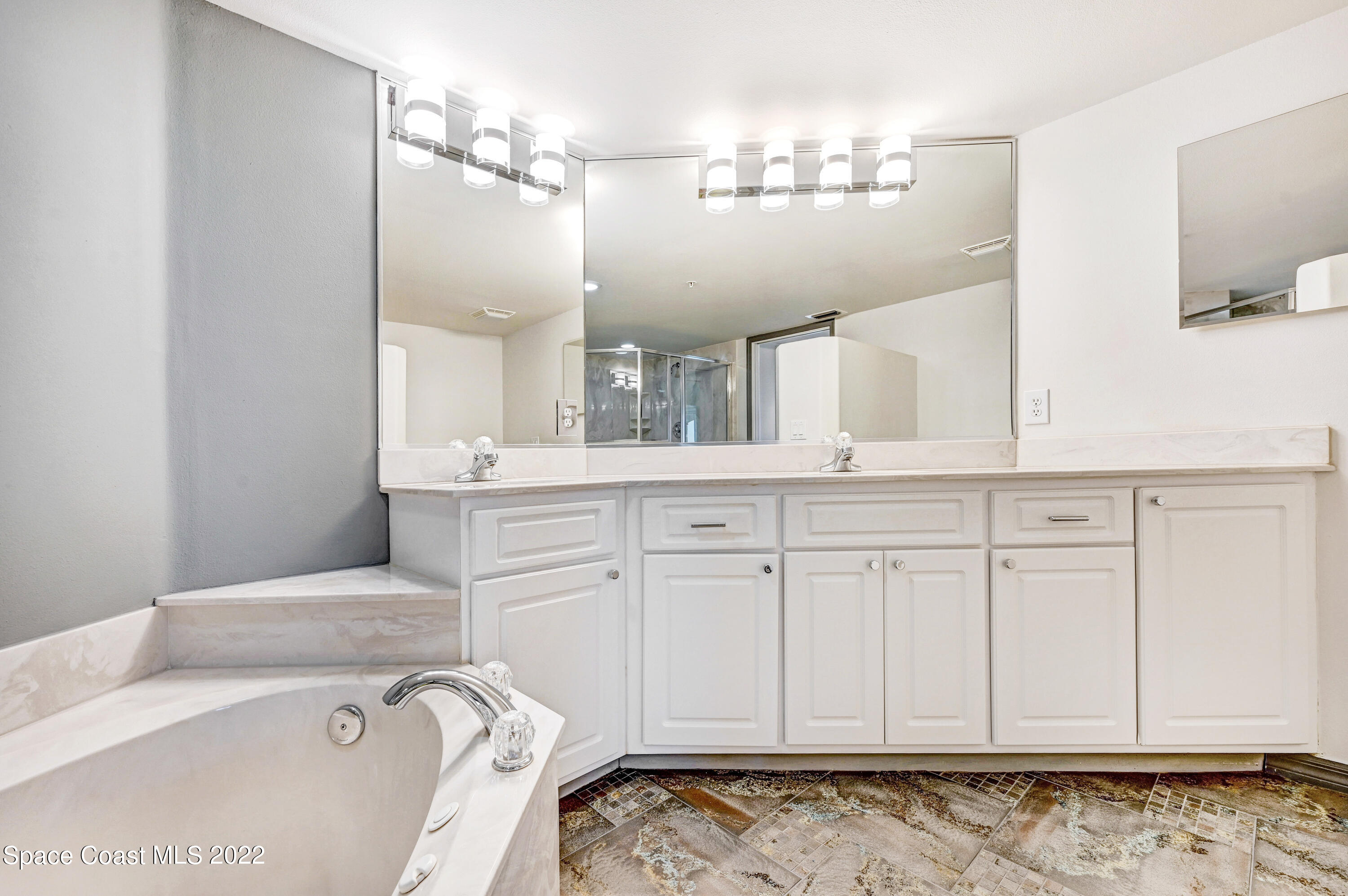 801 Del Rio Way, Unit 602 Merritt Island, FL 32953 - Photo 20 of 36 a bathroom with a sink and a mirror
