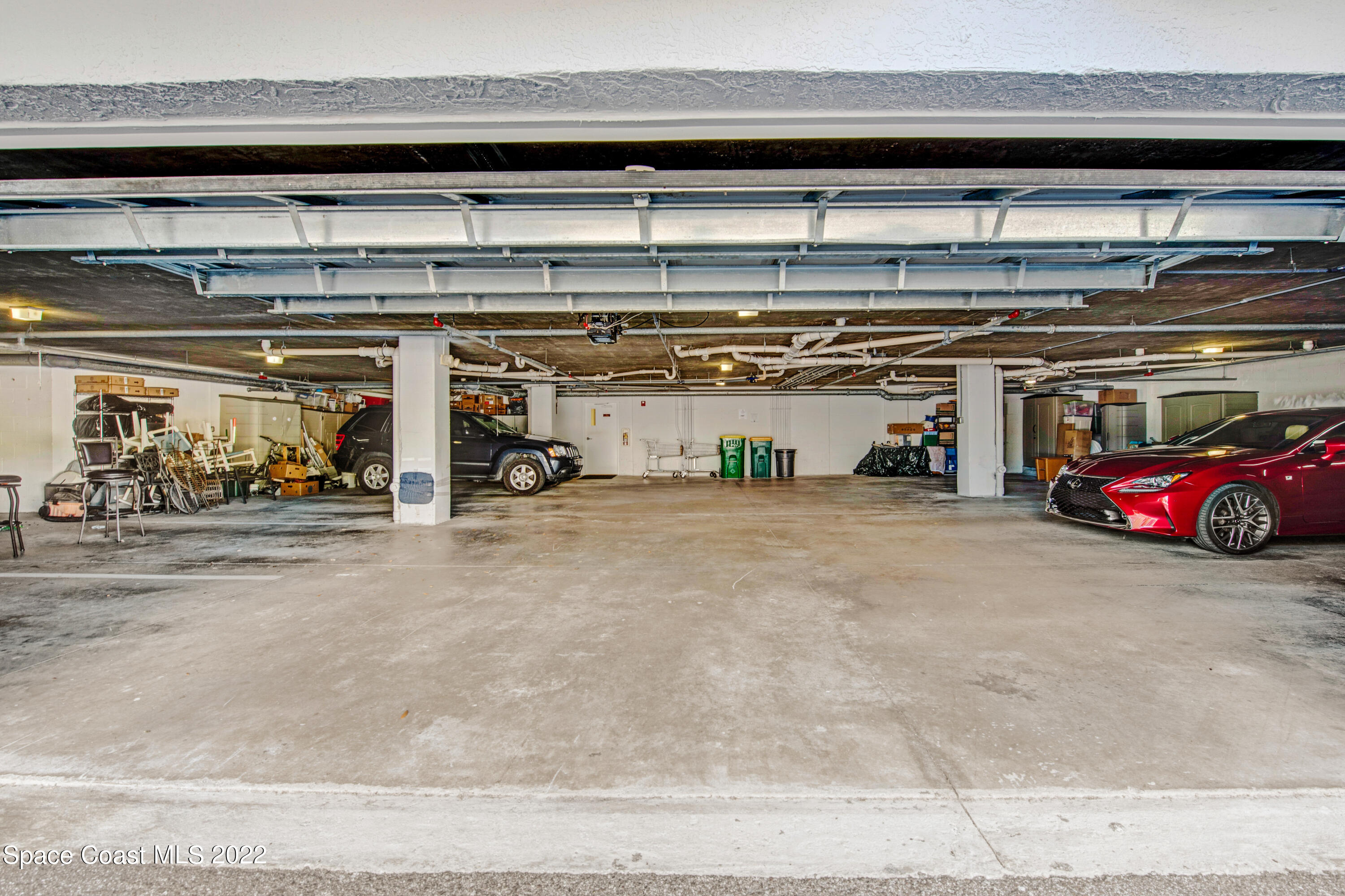 801 Del Rio Way, Unit 602 Merritt Island, FL 32953 - Photo 27 of 36 a view of parking garage with cars