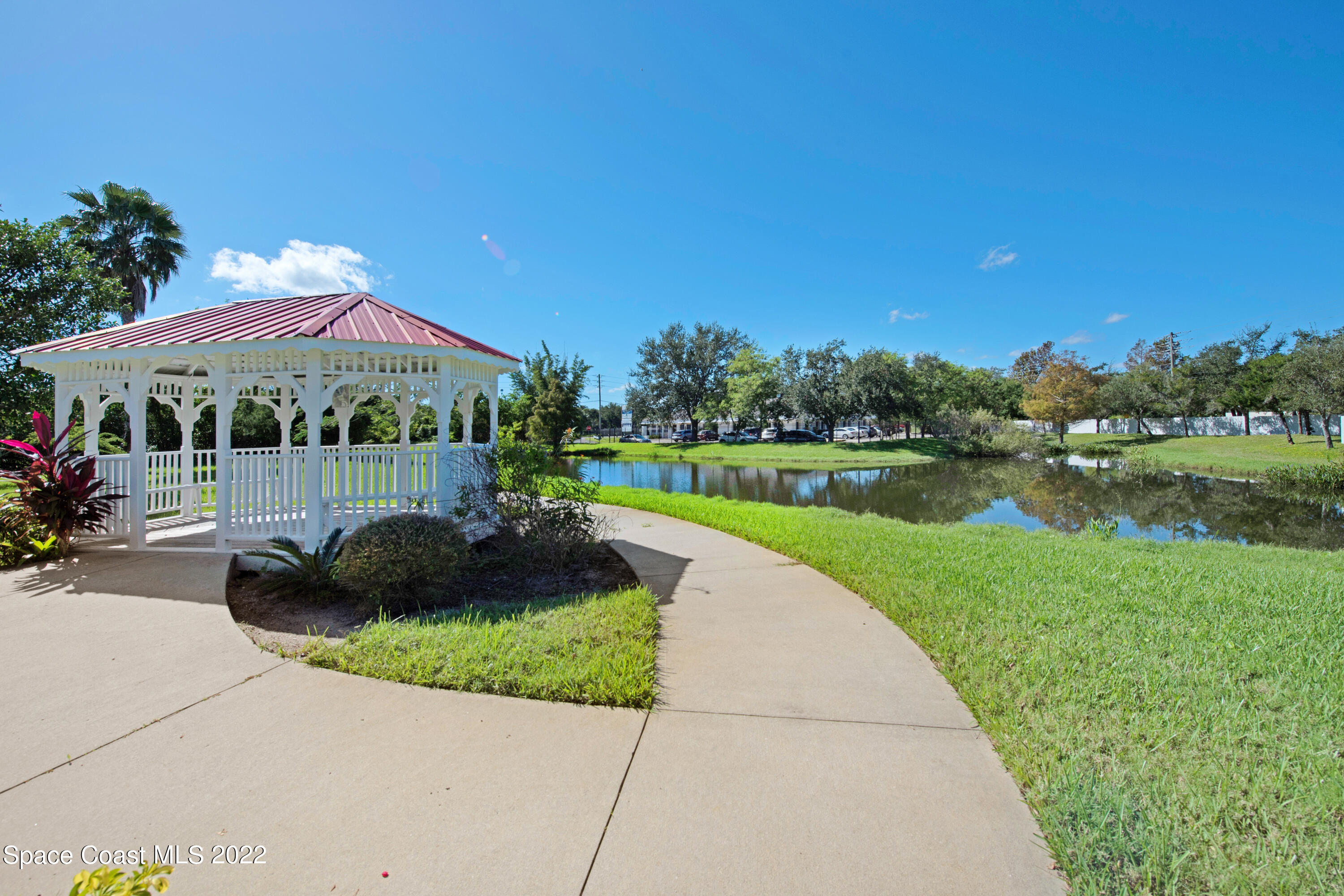 801 Del Rio Way, Unit 602 Merritt Island, FL 32953 - Photo 35 of 36 a view of a garden with a swimming pool and outdoor seating