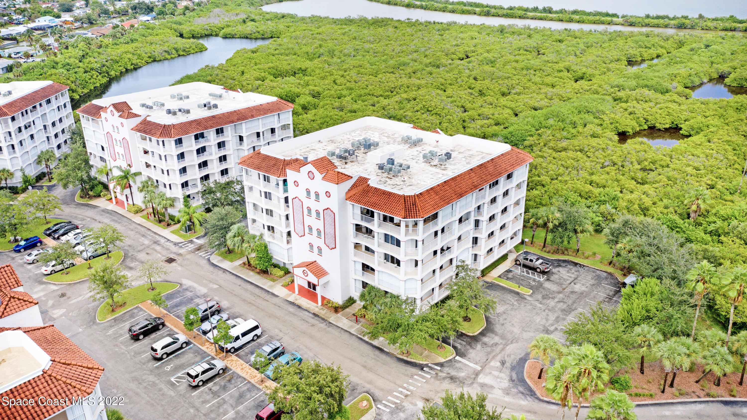 801 Del Rio Way, Unit 602 Merritt Island, FL 32953 - Photo 36 of 36 a view of a tall building with a yard