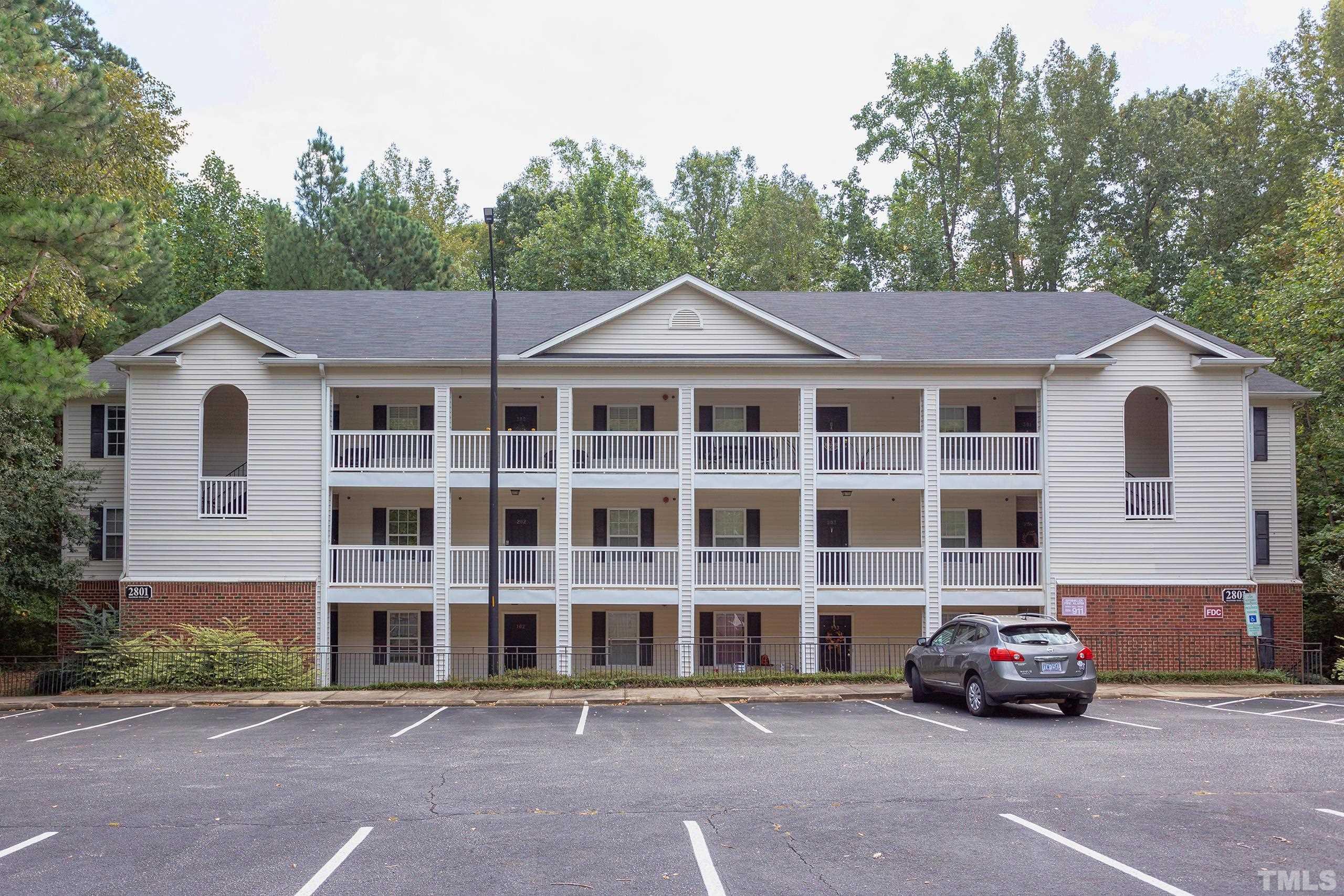 2801 Trailwood Pines Lane, Unit 102 Raleigh, NC 27603 - Photo 1 of 27 a car parked in front of a white house