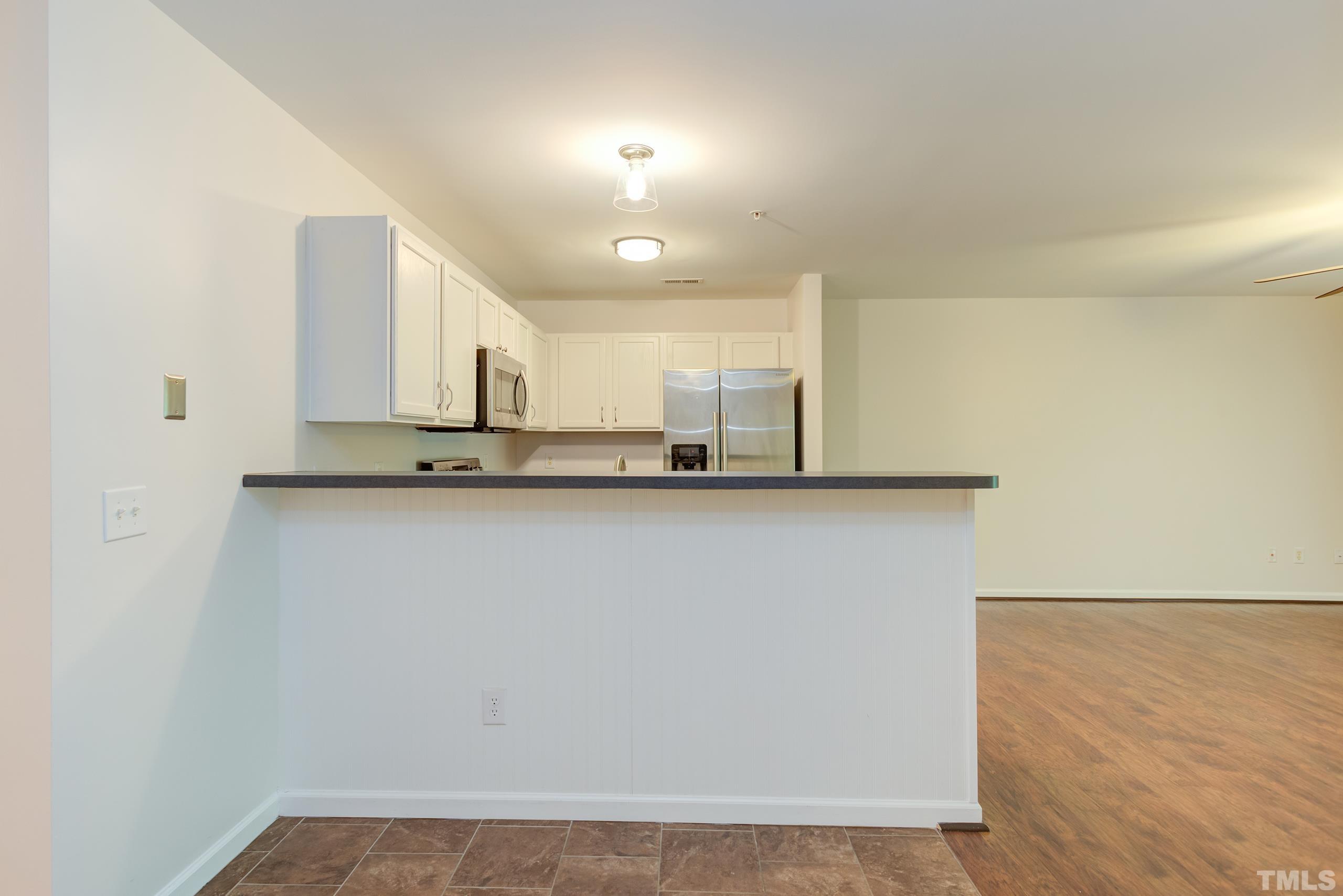 2801 Trailwood Pines Lane, Unit 102 Raleigh, NC 27603 - Photo 13 of 27 a view of a kitchen with a sink and dishwasher