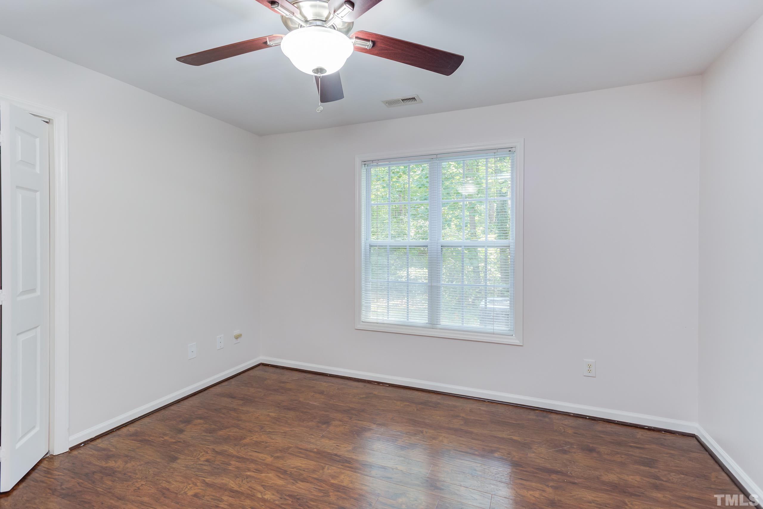 2801 Trailwood Pines Lane, Unit 102 Raleigh, NC 27603 - Photo 18 of 27 wooden floor in an empty room with a window