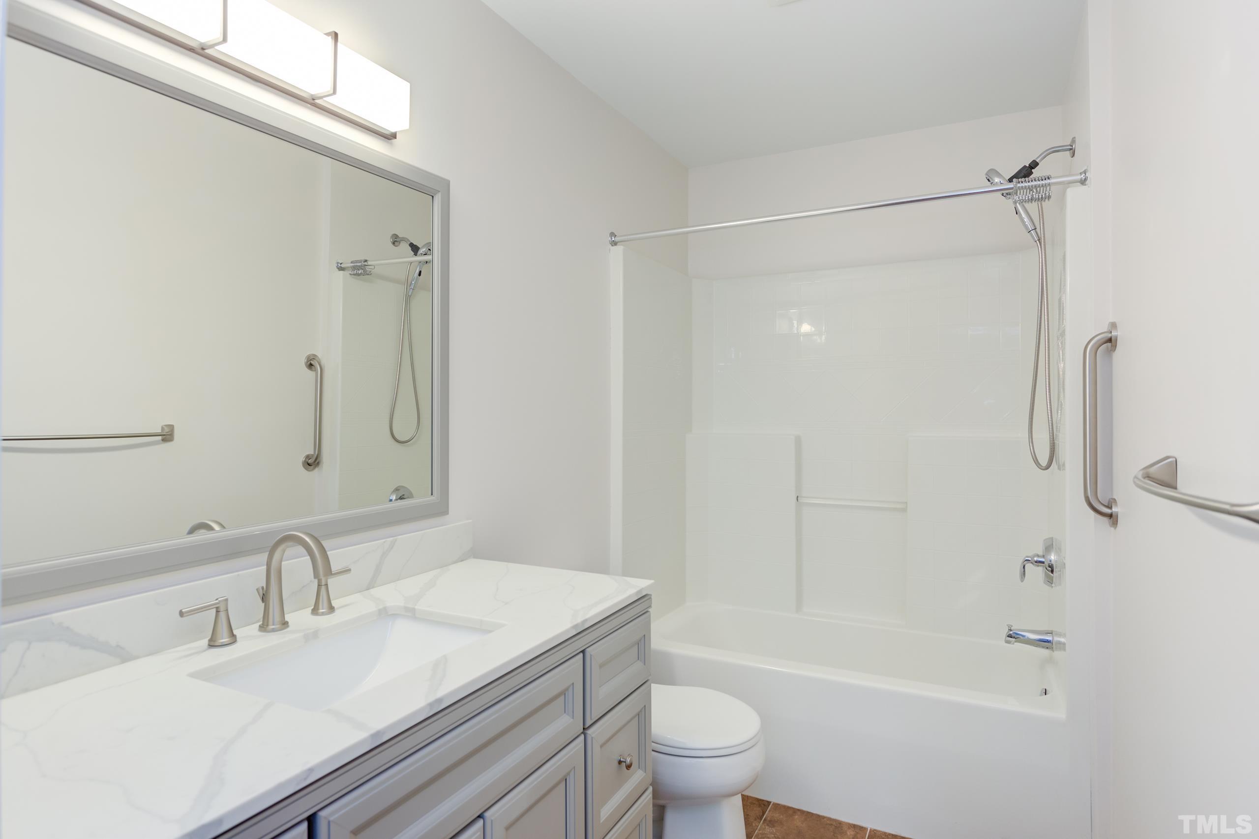 2801 Trailwood Pines Lane, Unit 102 Raleigh, NC 27603 - Photo 20 of 27 a bathroom with a sink toilet and shower