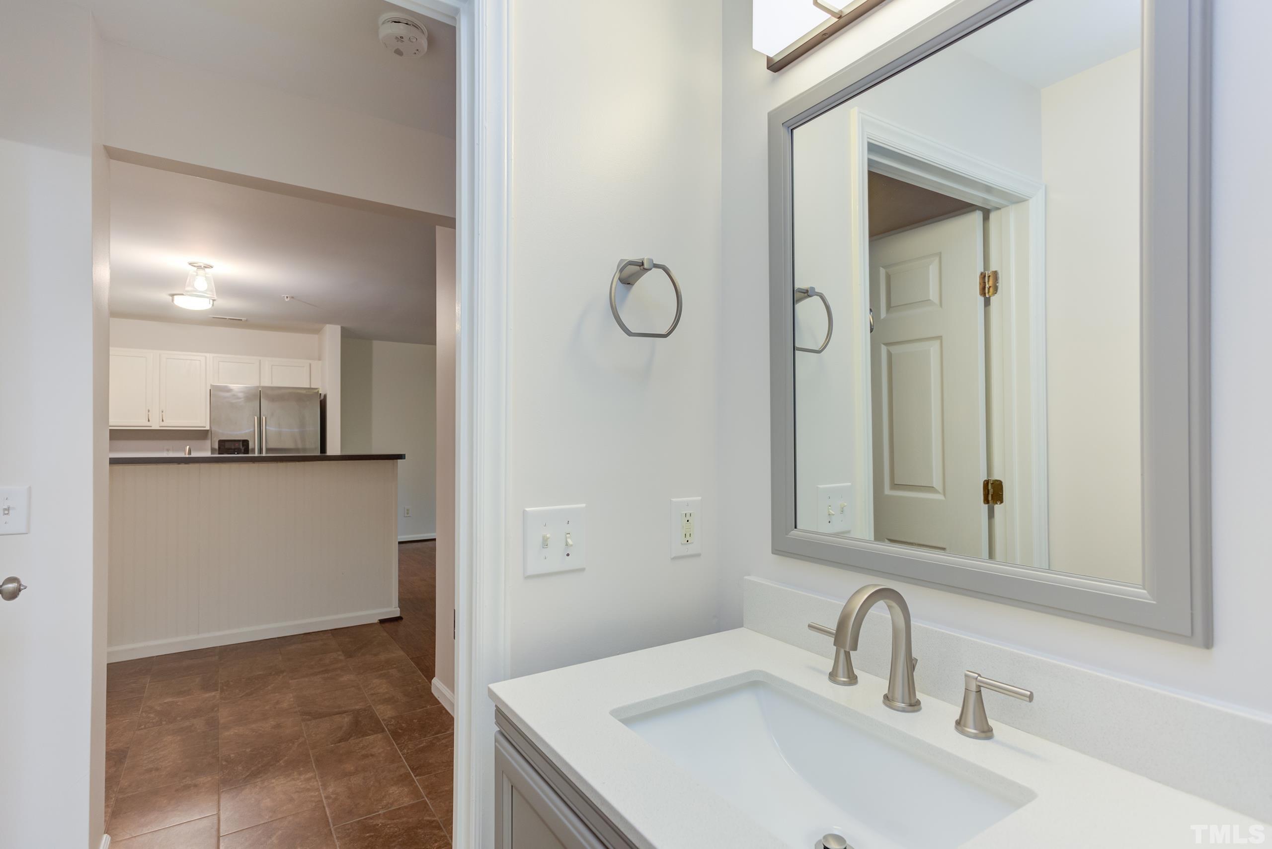 2801 Trailwood Pines Lane, Unit 102 Raleigh, NC 27603 - Photo 21 of 27 a bathroom with a sink and a mirror