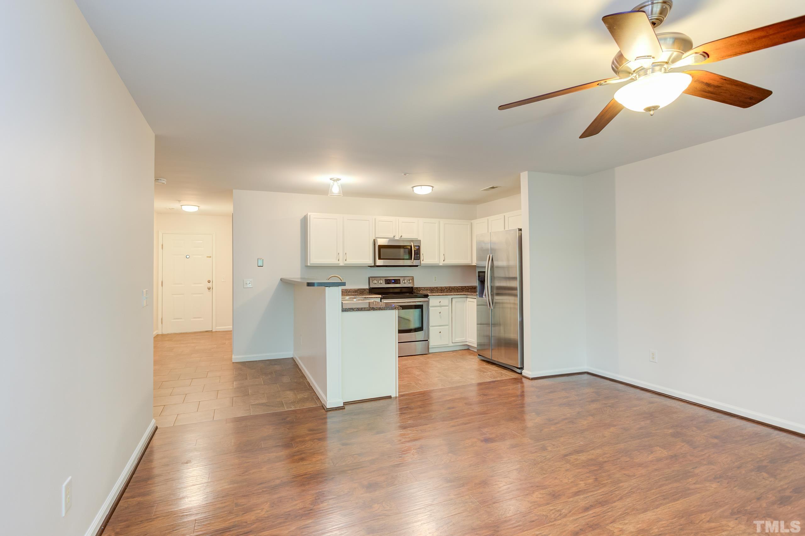 2801 Trailwood Pines Lane, Unit 102 Raleigh, NC 27603 - Photo 9 of 27 a view of kitchen with refrigerator microwave and stove