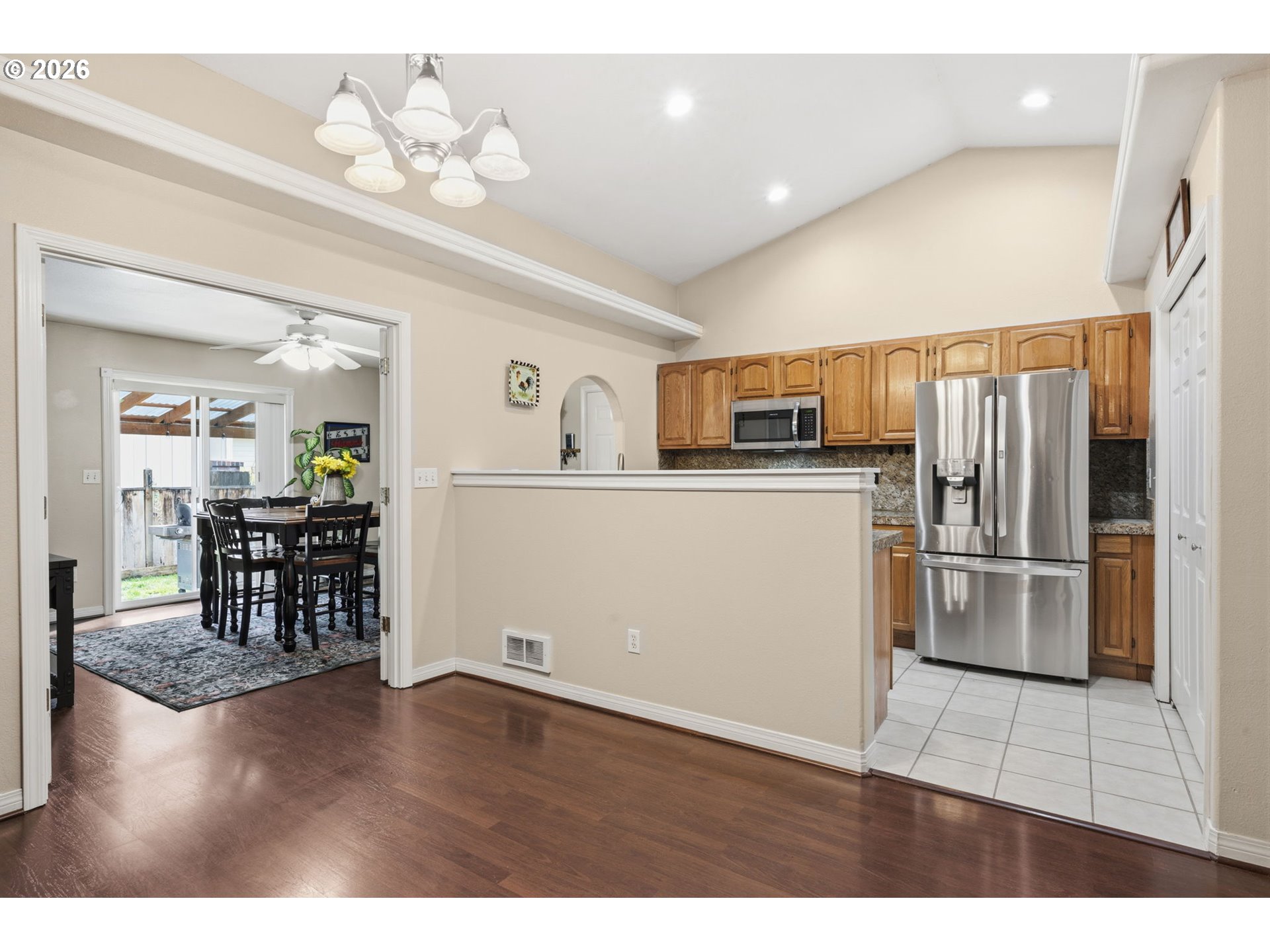 3653 Willowbrook Street Eugene, OR 97404 - Photo 11 of 43 a kitchen with granite countertop stainless steel appliances a refrigerator cabinets and wooden floor