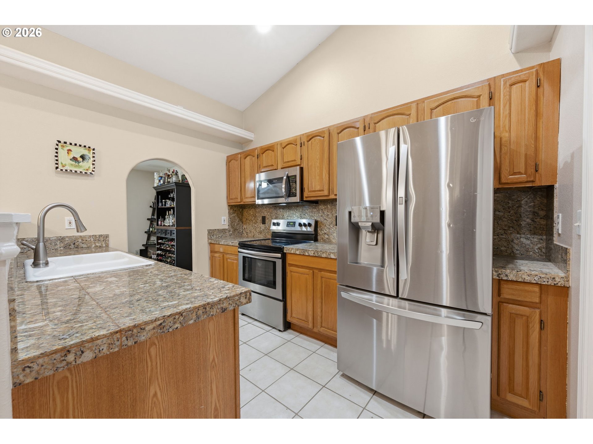 3653 Willowbrook Street Eugene, OR 97404 - Photo 12 of 43 a kitchen with granite countertop a refrigerator and a sink