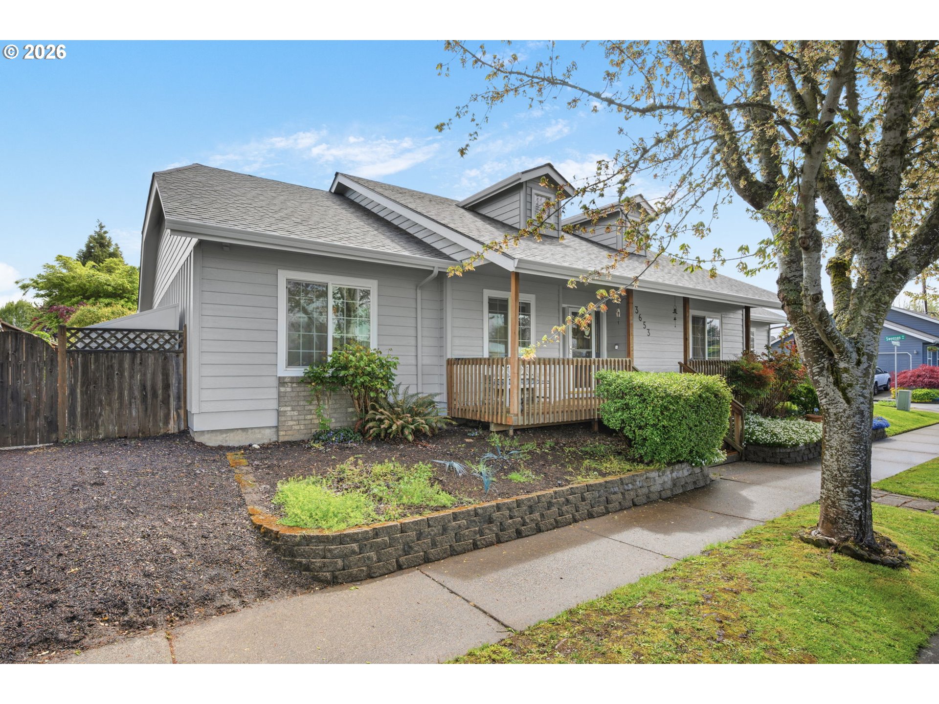 3653 Willowbrook Street Eugene, OR 97404 - Photo 2 of 43 a view of a white house next to a yard with potted plants