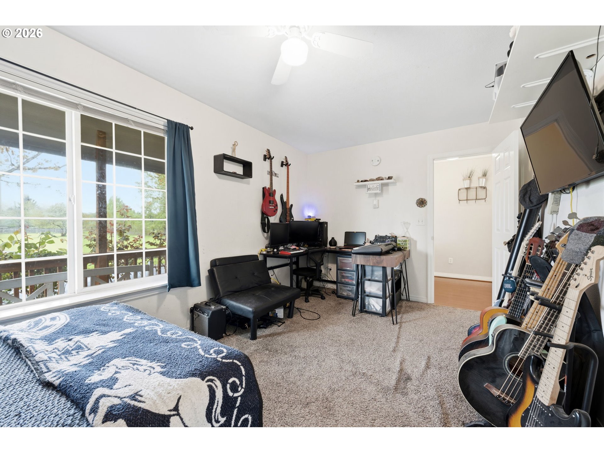 3653 Willowbrook Street Eugene, OR 97404 - Photo 22 of 43 a bedroom with furniture and a flat screen tv