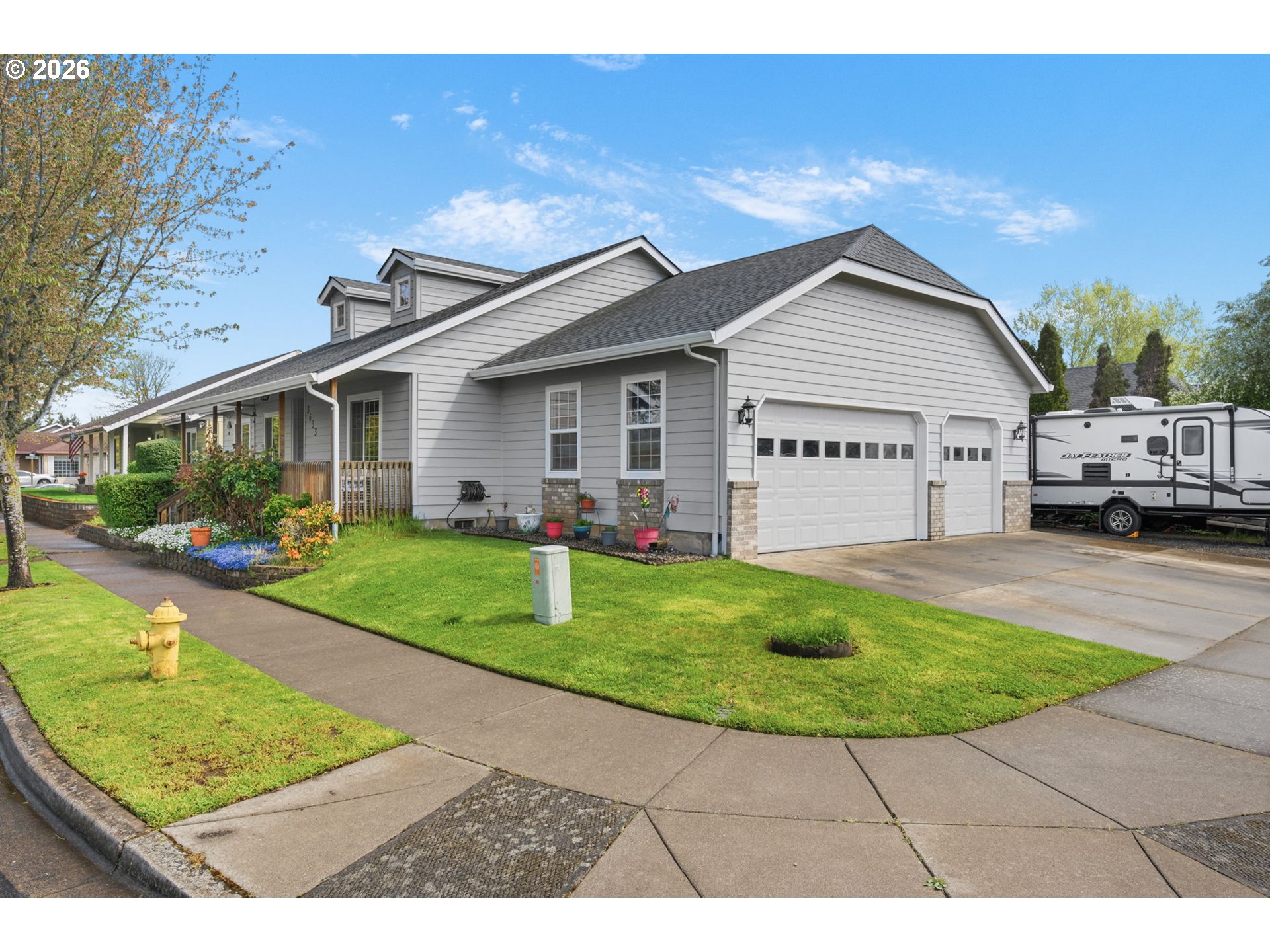 3653 Willowbrook Street Eugene, OR 97404 - Photo 3 of 43 a view of a white house in front of a yard with potted plants