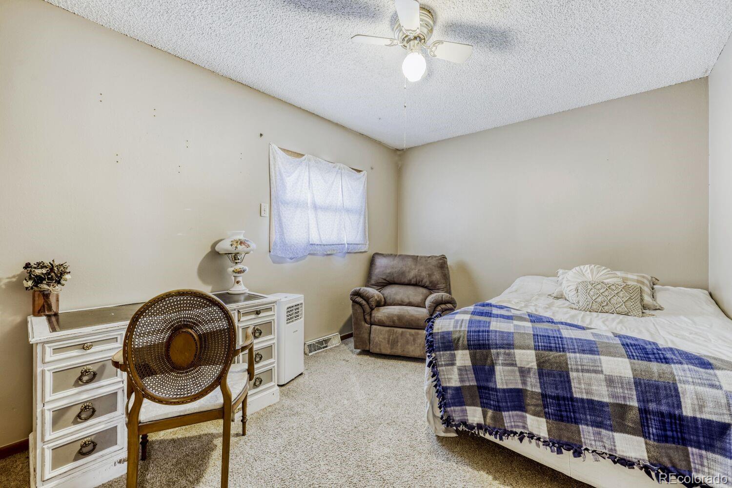 111 7th Street Fort Lupton, CO 80621 - Photo 18 of 22 a bedroom with bed and window