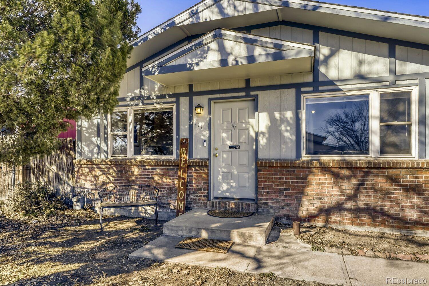 111 7th Street Fort Lupton, CO 80621 - Photo 3 of 22 a front view of a house with outdoor seating