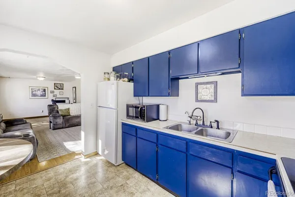 a kitchen with wooden cabinets and refrigerator
