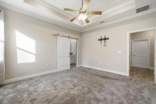 an empty room with fan and windows