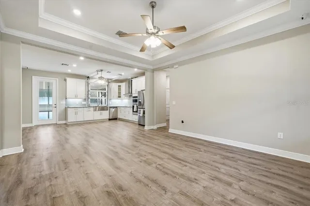 a view of empty room with wooden floor and window